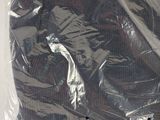 a plastic bag with a shirt in it sitting on a table