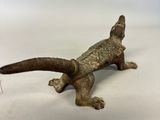 antique cast iron lizard figurine on white background