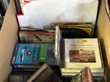 a cardboard box full of books and cds in it