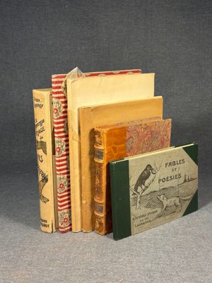 several books are stacked on top of each other on a table