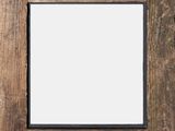 an old wooden picture frame with a blank white picture in the middle