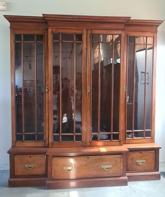 an image of a wooden entertainment center with glass doors
