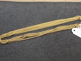 a gold chain with a heart charm on it