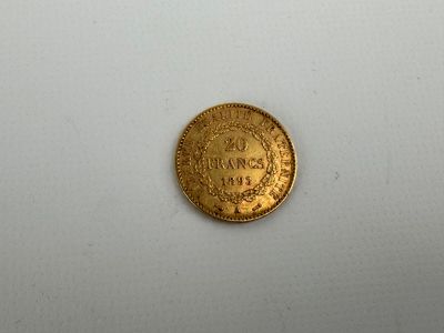 a close up of a gold coin on a white surface