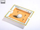 a golf ball in a box with a golf tee on it