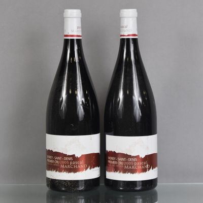two bottles of wine sitting on top of a table next to each other