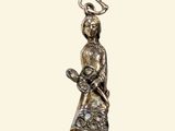 an image of a silver figurine of a woman with a bird on her shoulder