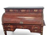an antique writing desk with a marble top and drawers