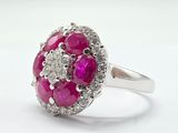 an image of a pink and white diamond ring on a white surface