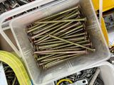 a container full of screws and screws on a table