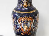 a blue and gold vase with a matching cup and saucer