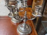 candlesticks on a table in a shop window display