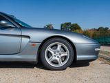 a silver sports car parked on the side of the road