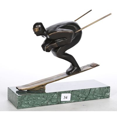 statue of a skier on a green base with a white background