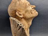 a close up of a statue of a man with a bird on his head