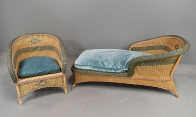 pair of wicker lounge chairs with blue cushions on a grey background