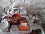 many bowls and cups sitting on a table next to each other