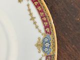 a close up of a plate on a wooden table