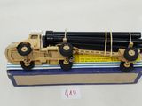 a toy truck that has a bunch of pipes on top of it