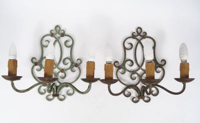 two wall sconces that are hanging on the wall
