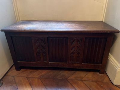 a wooden bench in the corner of a room