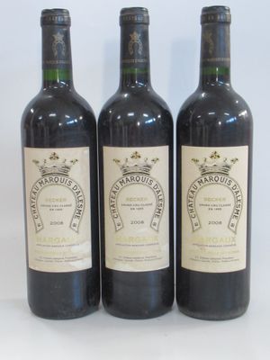 three bottles of wine are lined up on a white surface