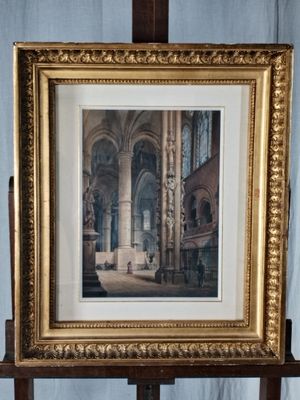 une vieille photo représentant une église, dans un cadre doré