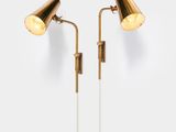 a pair of brass lamps on a white background