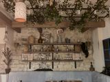 an image of a dining room with a stone wall
