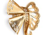 an image of a gold brooch with a butterfly on it
