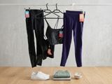two pairs of pants and a pair of sneakers on a table
