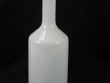 a white vase that is sitting on a black background