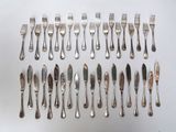 a lot of forks and spoons that are on the table