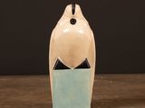 a ceramic bird that is sitting on top of a table