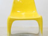 a yellow chair with white legs and a white base