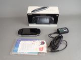 a box with a remote and a cell phone in it