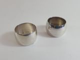 pair of silver plated sugar and creamers on a white surface