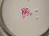 a white plate with a pink design on it