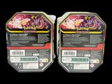 two packs of pokemon trading cards are shown on a black background