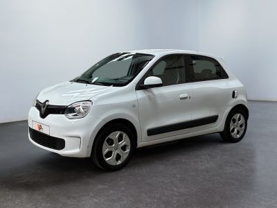 the small white car is parked in a white room