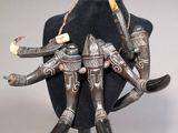 an image of a statue of a man holding a knife and a sword