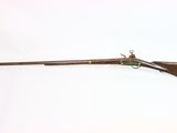 an old rifle with a wooden handle on a white background