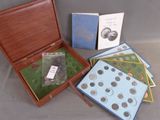 a lot of coins in a wooden box on a table