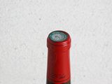 a bottle of wine sitting on a wooden table