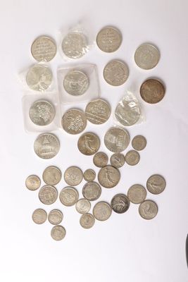 a lot of coins on the table next to a calculator and a calculator