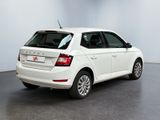 the rear end of a white car parked in a room