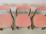 three pink chairs sitting next to each other on a carpeted floor