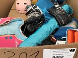 a cardboard box filled with skates and other items