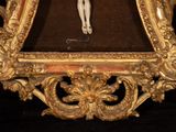 a picture of jesus on the cross in a gold frame