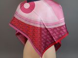 a close up of a pink scarf on a mannequin head
